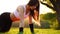 Push ups or press ups exercise by young woman. Girl working out on grass crossfit strength training in the glow of the