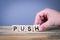 Push. Wooden letters on the office desk