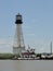 A pushboat prepares absorbent booms at the Venice, Louisiana lighthouse for use following the Deepwater Horizon disaster