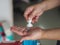 Pushing Gel drops on hand  Woman holding gel Hand Sanitizer, gel alcoholic mixture with gelatin in clear Plastic bottle with pump