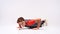 Pushing limits. Full-length shot of a teenage boy engaged in sport, looking at camera while doing push-ups. Isolated on