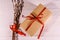 Pussywillow bouquet and cardboard gift box on a wooden table. Top view