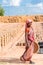 PUTTAPARTHI, ANDHRA PRADESH, INDIA - JULY 9, 2017: Indian woman on a background of drying bricks. Copy space for text. Vertical.