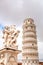 Putti fountain with Pisa tower in Italy