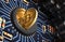 Putting Bitcoin Into Coin Slot On Blue Motherboard And Creating Heart Shape With Reflection