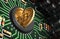 Putting Bitcoin Into Coin Slot On Green Motherboard And Creating Heart Shape With Reflection