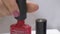 Putting Brush In The Bottle Of Red Nail Polish