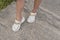 Putting on a comfy and stylish white sandals with gold chains design. Wearing the new and fashionable footwear style made from