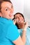 Putting dental braces to the woman`s teeth at the dental office. Dentist examine female patient with braces in dental