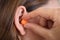 Putting Earplug Into Her Ear