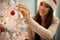 Putting the final touches on the Christmas tree. an attractive young woman decorating a Christmas tree.