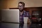 Putting in the hours. a trendy young man using his laptop at a desk.