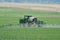 Putting liquid fertilizer on crop field.