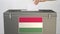 Putting paper ballot into ballot box with flag of Hungary. Voting related 3d rendering