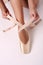 Putting on pointe ballet shoes