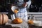 Putting pumpkin puree in the glass bowl horizontal