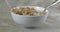 Putting a spoon in a bowl of almond granola