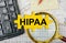 Puzzle with a calculator, magnifying glasses and financial documents in the center inscription -HIPAA