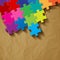 Puzzle colorful on a crumpled paper brown background.