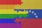 puzzle with the flag of rainbow gay pride and venezuela . macro.concept