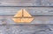 Puzzle in the form of a boat on a wooden background