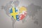 Puzzle heart with the national flag of sweden and bhutan on a world map background. Concept