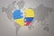 Puzzle heart with the national flag of ukraine and colombia on a world map background. Concept