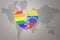 Puzzle heart with the rainbow gay flag and venezuela on a world map background. Concept