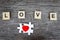 Puzzle jigsaw forming red heart and text wooden blocks spelling the word LOVE and on rustic brown wooden surface, romantic