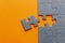 Puzzle. Many puzzle pieces on an orange background. The concept of collective thinking