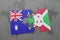 puzzle with the national flag of australia and burundi on a world map background.