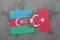 puzzle with the national flag of azerbaijan and turkey on a world map background.