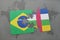 puzzle with the national flag of brazil and central african republic on a world map background.