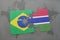 puzzle with the national flag of brazil and gambia on a world map background.