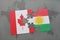 puzzle with the national flag of canada and kurdistan on a world map background.