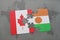 puzzle with the national flag of canada and niger on a world map background.