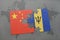 puzzle with the national flag of china and barbados on a world map background.
