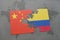 puzzle with the national flag of china and colombia on a world map background.