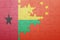 Puzzle with the national flag of china and guinea bissau