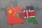 puzzle with the national flag of china and kenya on a world map background.