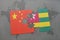 puzzle with the national flag of china and togo on a world map background.