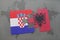 Puzzle with the national flag of croatia and albania on a world map background.