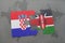 puzzle with the national flag of croatia and kenya on a world map