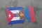 puzzle with the national flag of cuba and mongolia on a world map background.