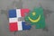 puzzle with the national flag of dominican republic and mauritania on a world map