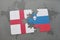 puzzle with the national flag of england and slovenia on a world map background.