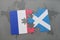 puzzle with the national flag of france and scotland on a world map background.