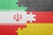 Puzzle with the national flag of germany and iran