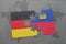 puzzle with the national flag of germany and liechtenstein on a world map background.