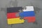 puzzle with the national flag of germany and russia on a world map background.